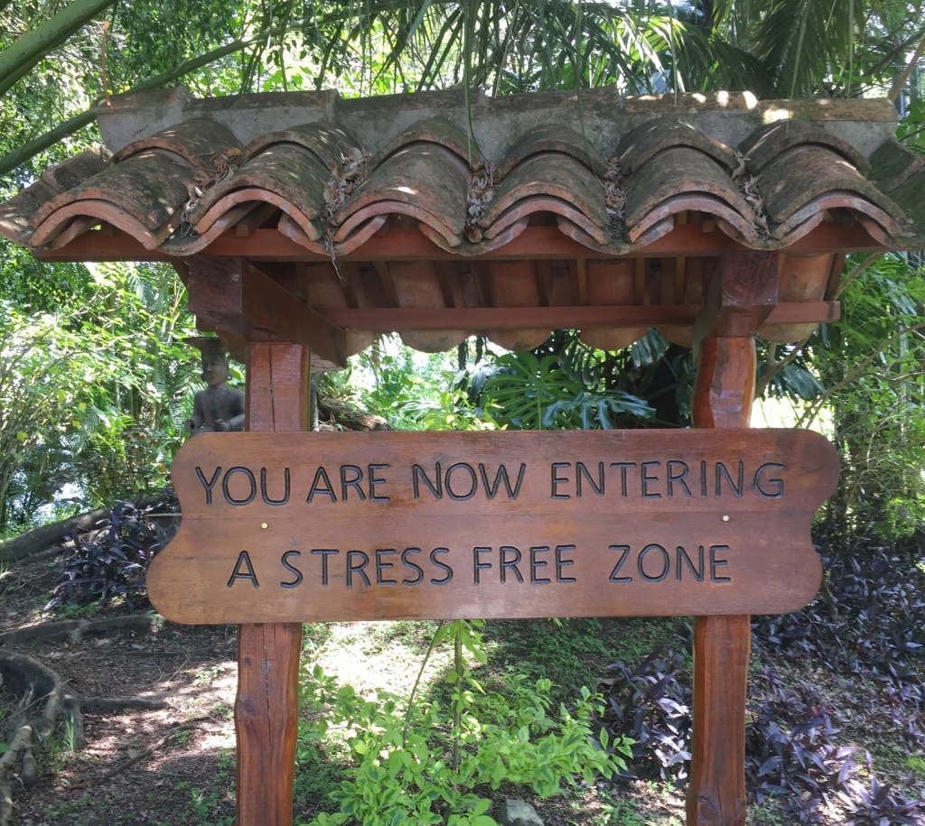 photo of a wooden sign reading "You are now entering a stress free zone"