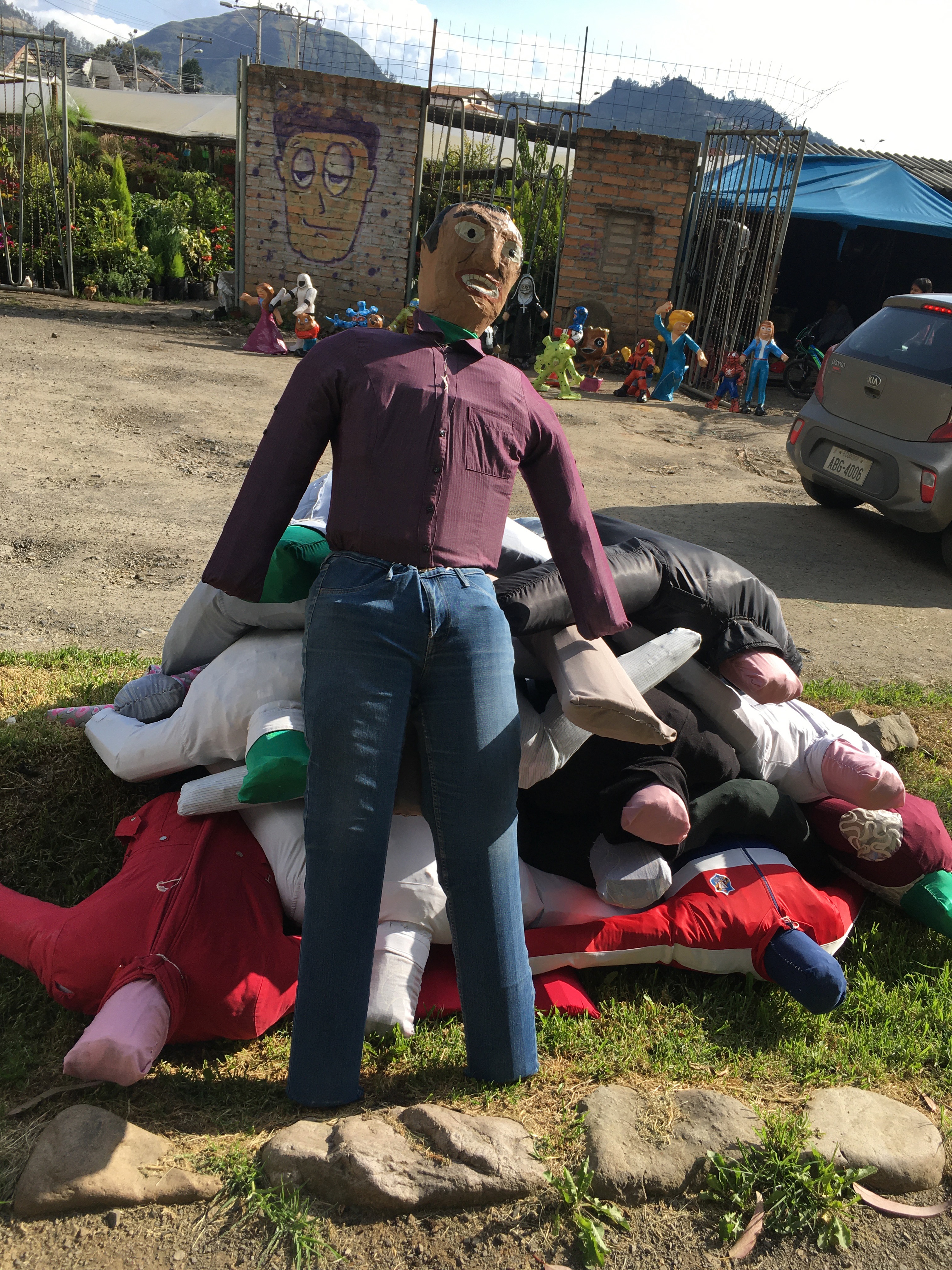 Photo of a stack of human-formed dummies in a vacant lot.